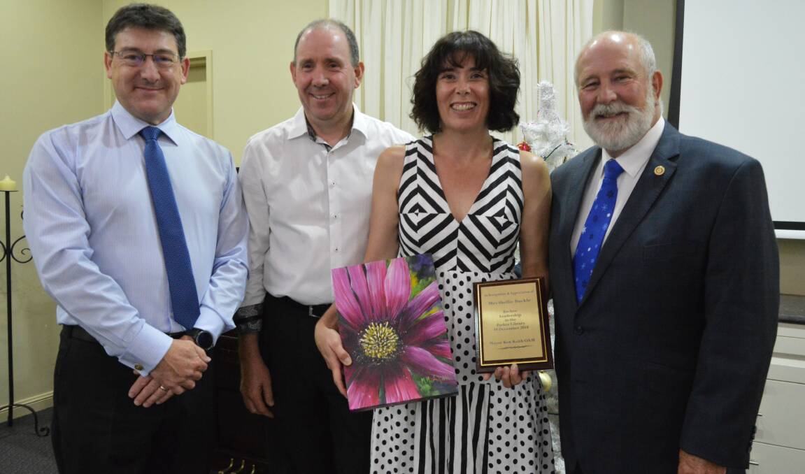 GOODBYE: Parkes Shire Council's Technology and Corporate Services Director Les Finn (left) and Mayor Ken Keith OAM (right) - along with other council colleagues - farewelled Craig and Shellie Buckle at the council Christmas party hosted by the mayor on Tuesday.