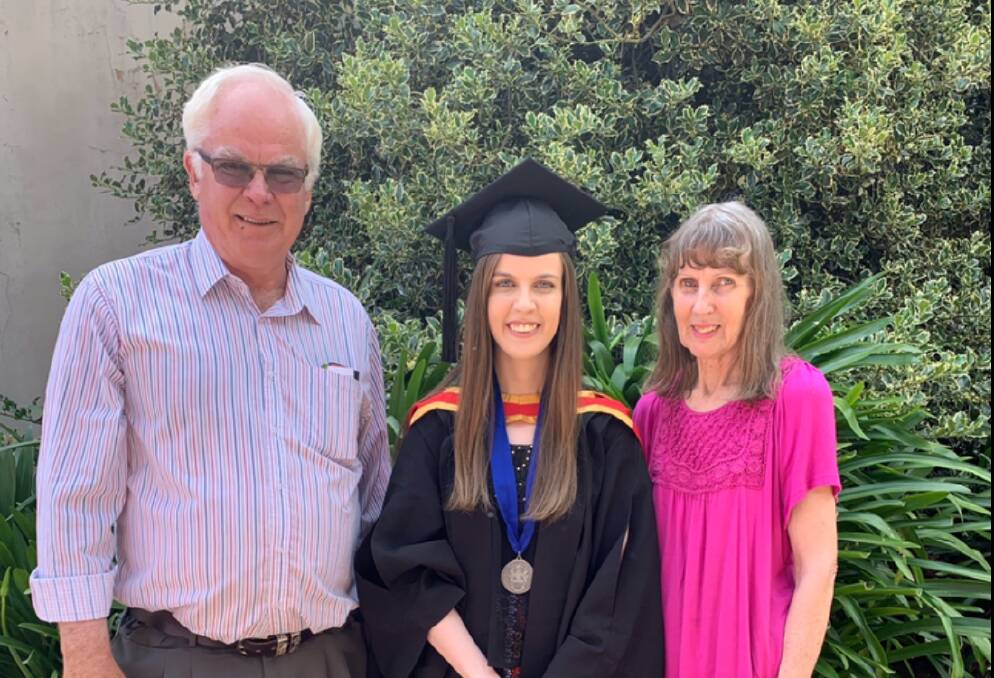 HONOURED: Parkes woman Peta O'Brien, proudly wearing her University medal, is pictured with her parents, Tim and Judy O'Brien. Photo: Supplied.