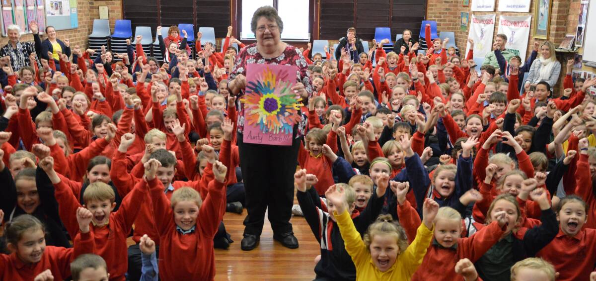 Middleton Public School canteen supervisor Barbara Osbourne was flattered with the cards and posters made by students, given to her during a special assembly on her last day.