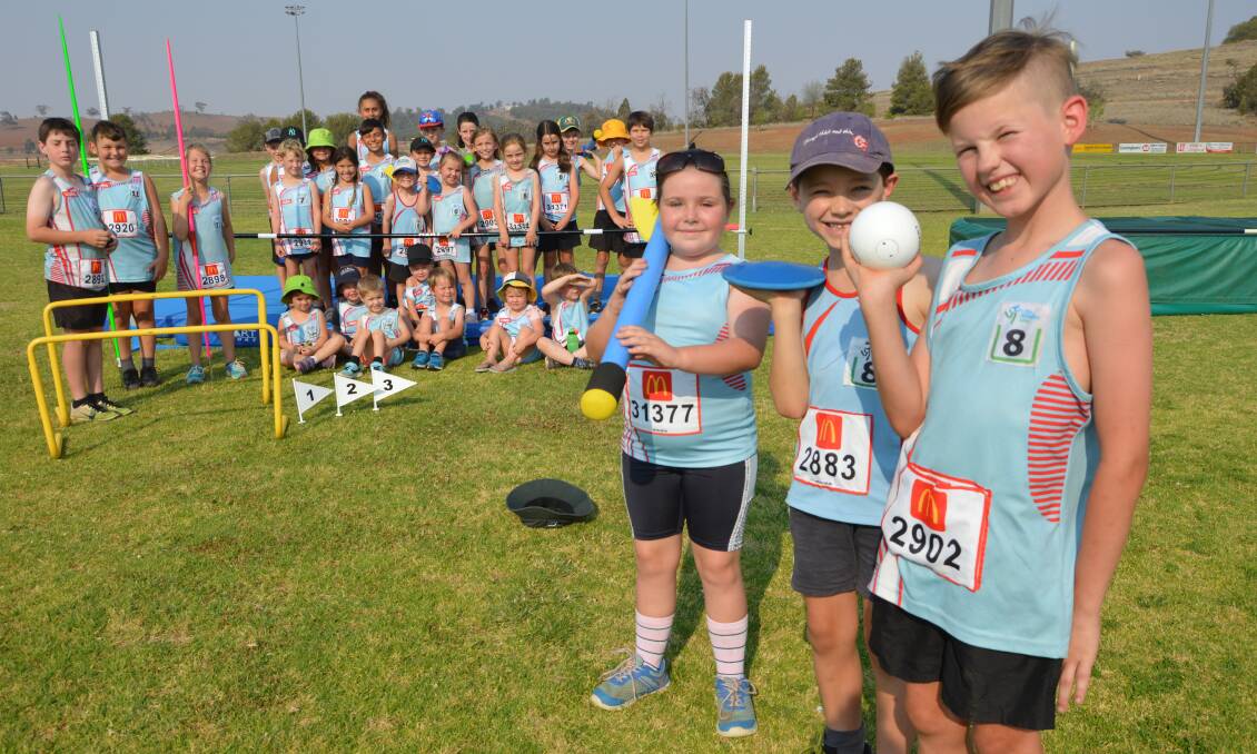 HAPPY ATHLETES: Lily Jeffreys (8), Rhys Hutchins (7) and Ayden Doering (8) and their Parkes Little Athletics team mates are thrilled to receive new sporting equipment thanks to a grant. Photo: Christine Little