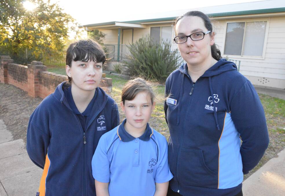 DESPERATE: Elisha Littlewood, who's been a Girl Guide for 12 years, and Caitlin Douglas, a Guide for six months, are the only two Parkes Girl Guides left. Parkes leader Joanne Buerckner (right) said the club will sadly face closure if they can't recruit more members.