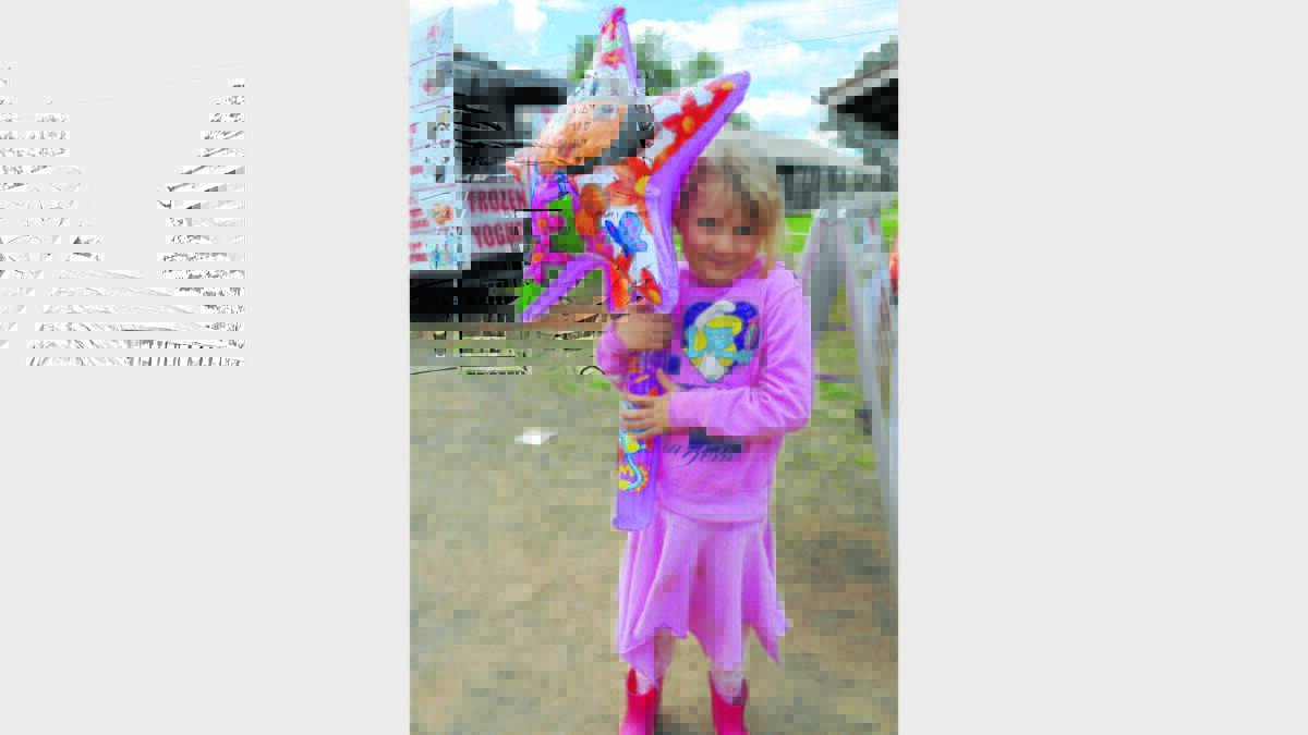 Pretty in pink Lara Dennis (6) from Peak Hill was very happy with her Dora Star Balloon.