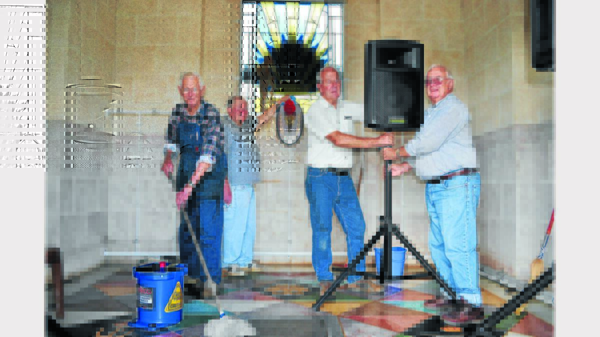 Pictured tidying up the sanctum inside the Memorial Hill monument yesterday were (left to right) Alan Hourigan, Terry Knowles, Bob Brooke and Arthur Parker. Photo: Bill Jayet.    