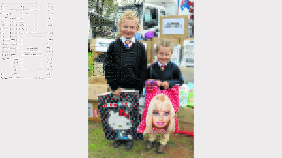 Looking particularly cute at Wednesday’s Peak Hill Show are Laci (6) and Teila (5) Kremer from West Wyalong, taking a break from their horse riding events to buy their favourite showbags.  The show was held in glorious conditions and attracted a terrific crowd.  Photos: Barbara Reeves.