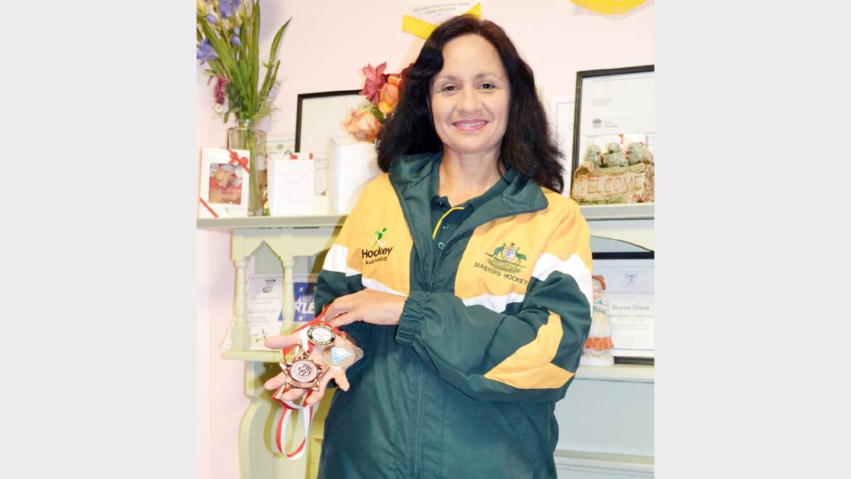 Local physio Sharon Dixon will be hoping to return from the Masters World Cup next June with another medal like the ones she displayed here. Photo: Denis Howard